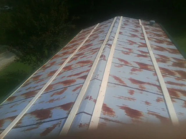 Rusted metal roof panels with new wood purlins before replacement — Storm Damage Roof Repair in Buckland by Roofing Brothers